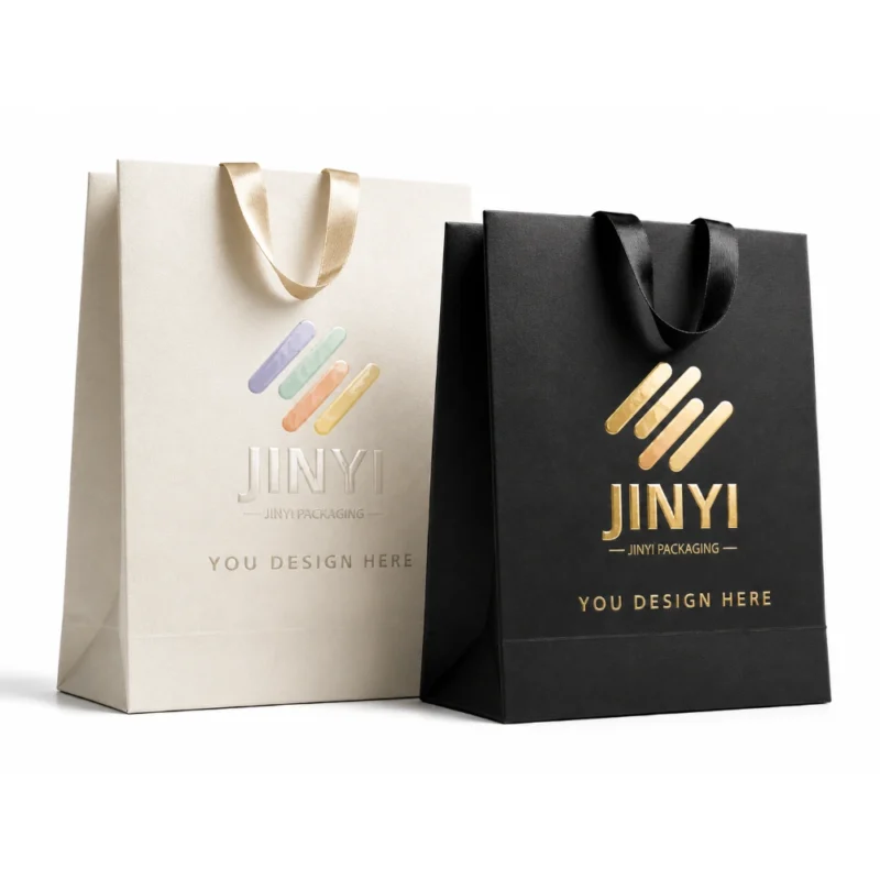 Custom gift bags in white and black kraft paper with ribbon handles — JINYI