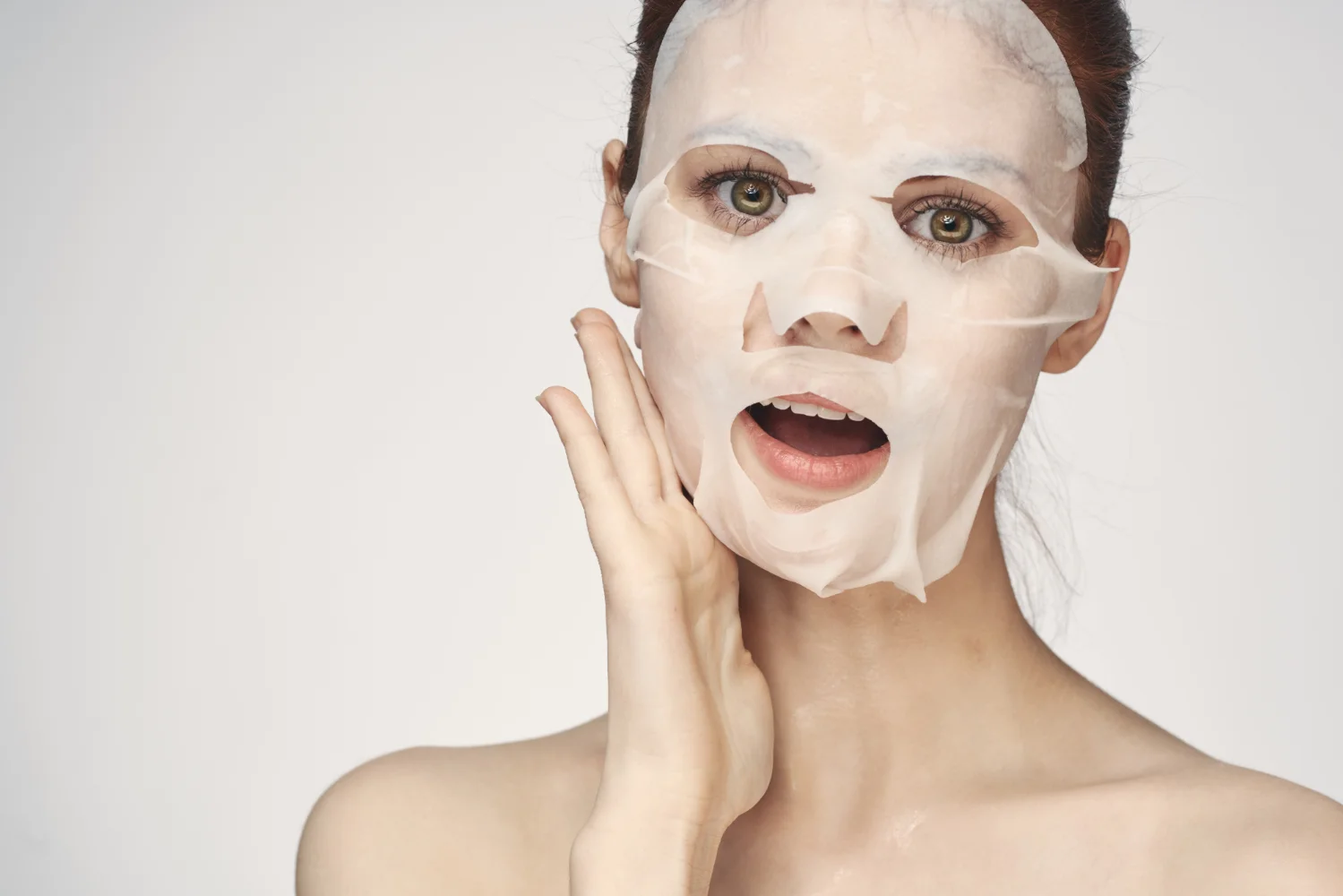 pretty woman naked shoulders face mask closeup skin care