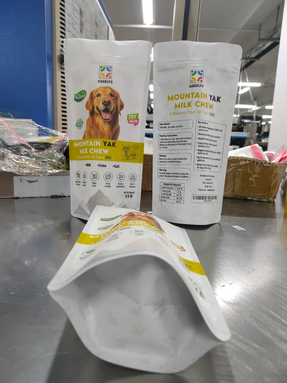 JINYI custom white matte stand-up pouch for pet food — factory production photo showing flat-bottom format with full-colour print