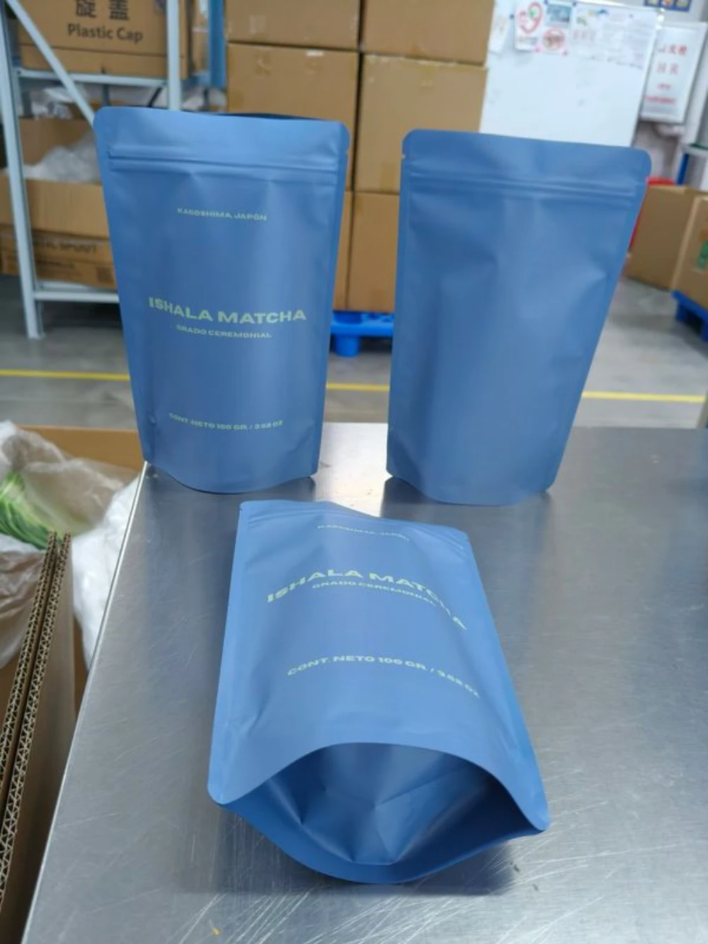 JINYI custom blue matte stand-up pouches in production — factory-direct flexible packaging in custom colourways