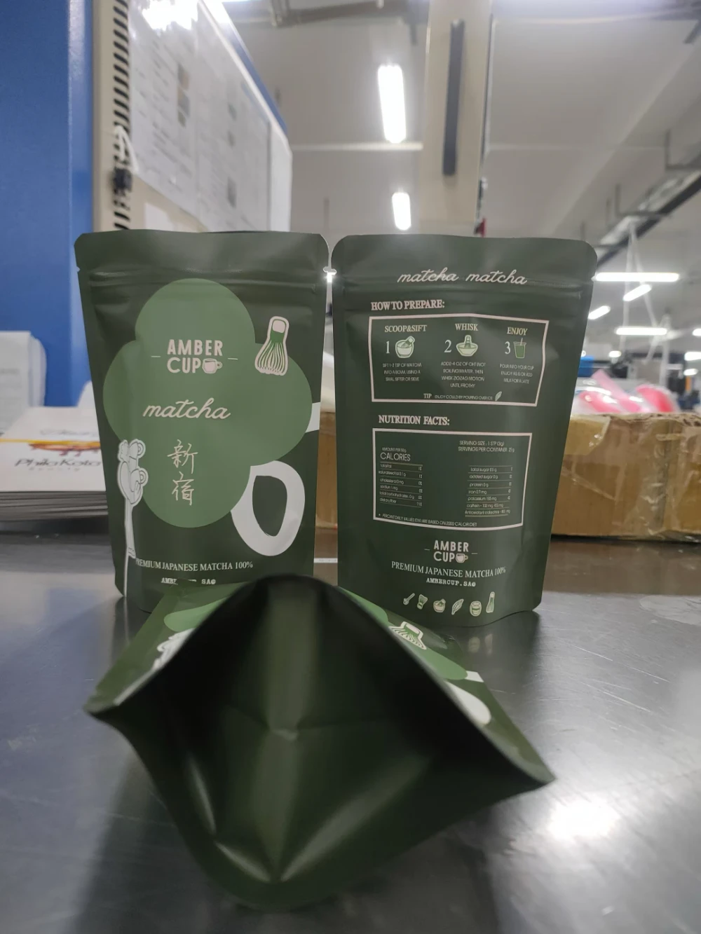 JINYI custom dark green flat-bottom matcha bags with brand artwork — premium matcha packaging produced factory-direct