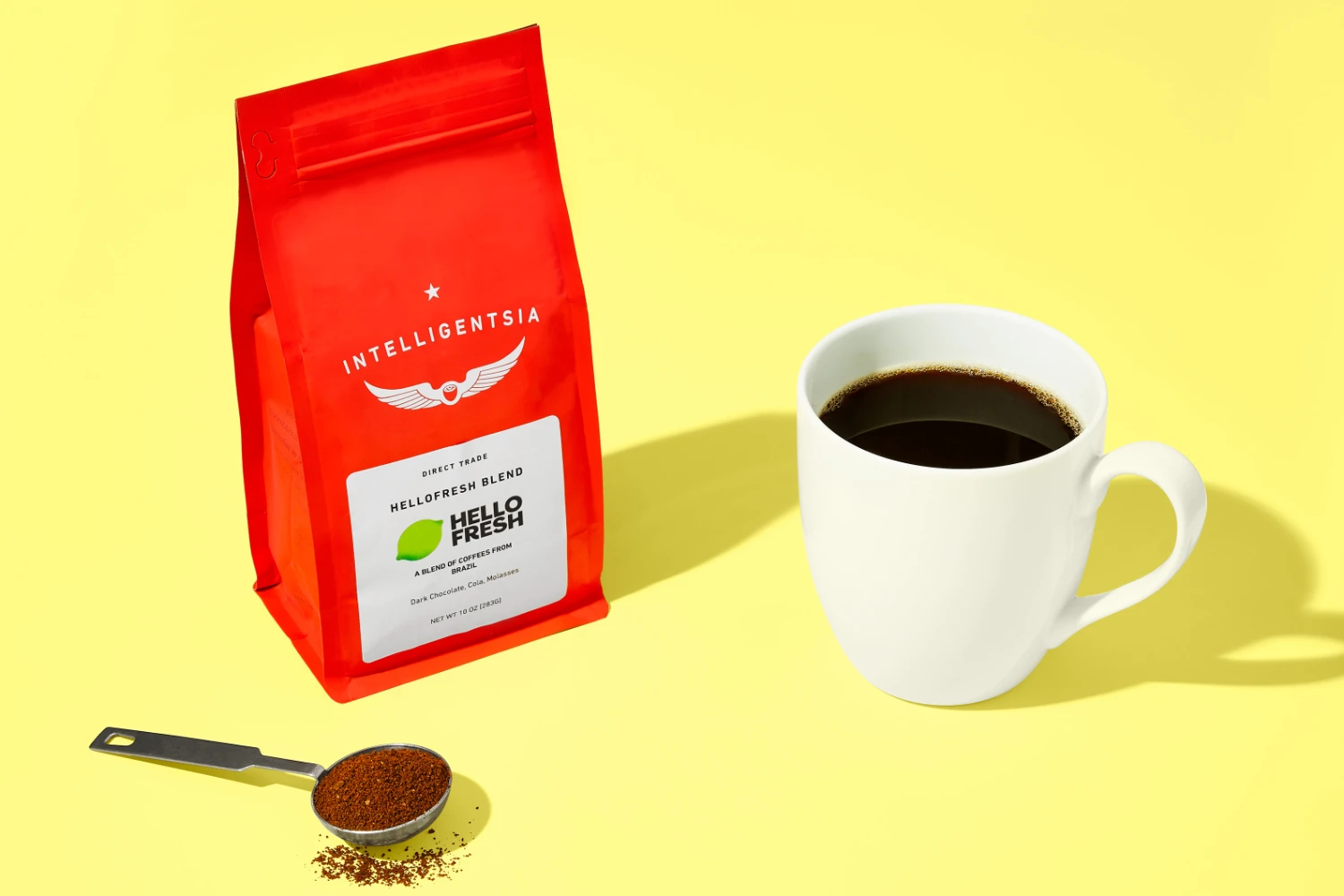 Intelligentsia Coffee red signature blend bag with coffee cup — specialty coffee packaging lifestyle shot