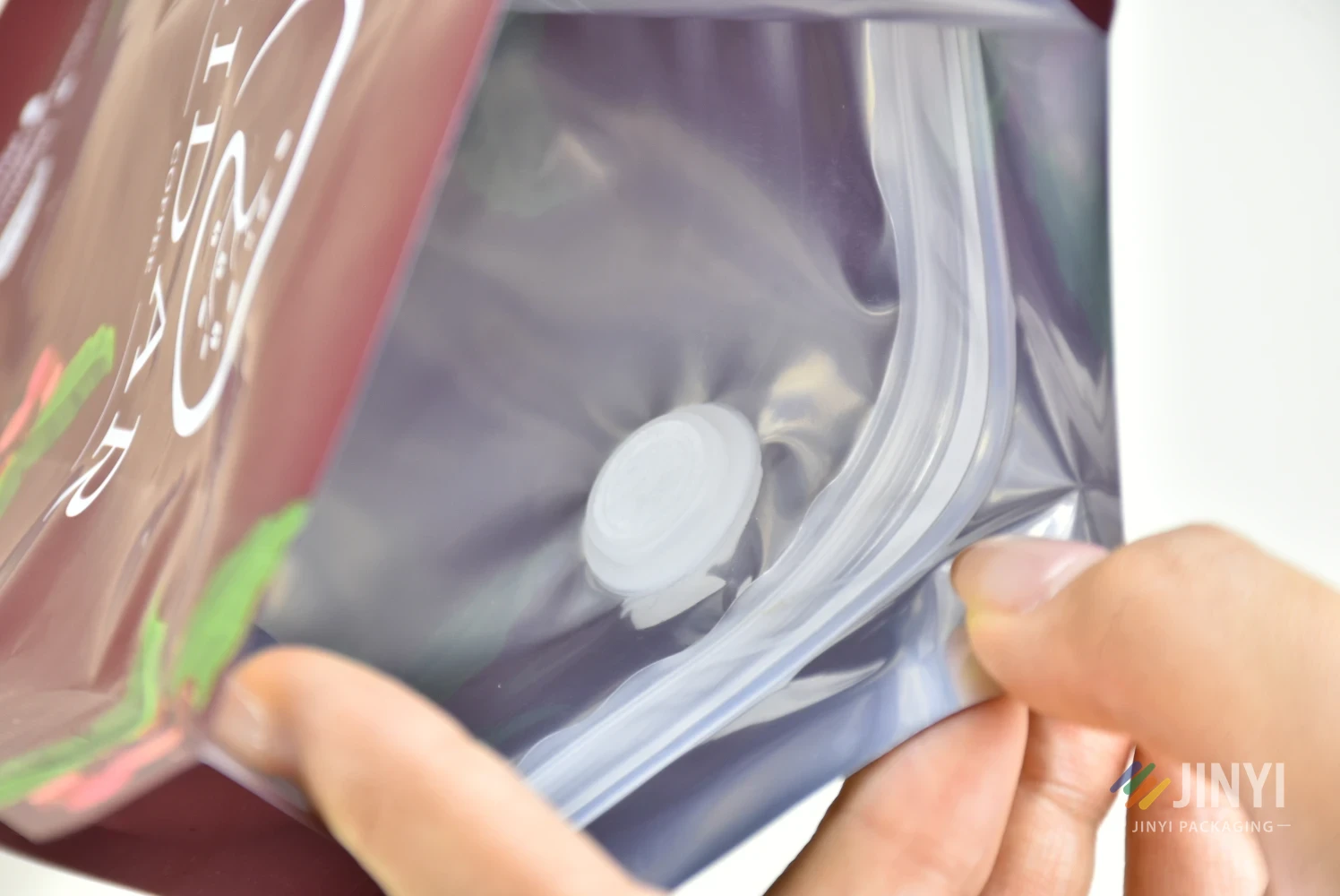 One-way degassing valve on a custom coffee pouch — allows CO₂ to escape while keeping oxygen out, essential for freshly roasted coffee