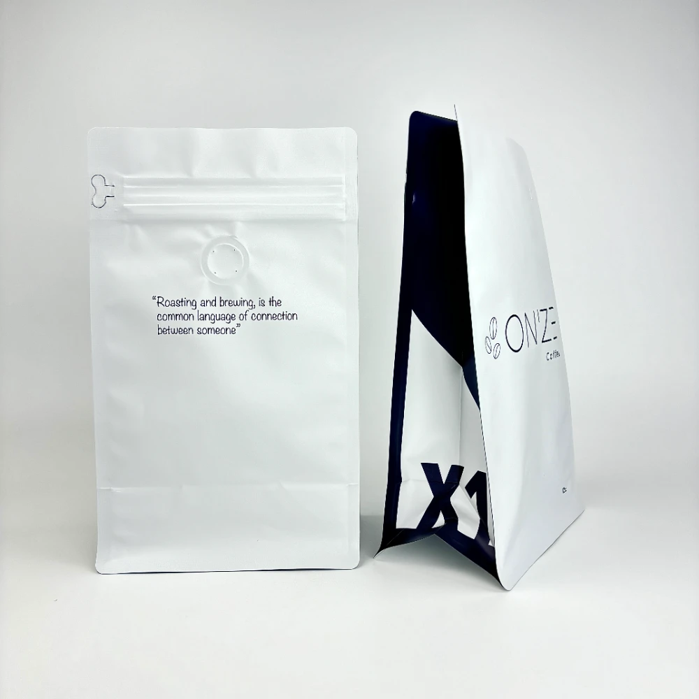 JINYI custom white flat-bottom coffee bags — factory-direct specialty coffee packaging with minimal print design and structured base from 500 units