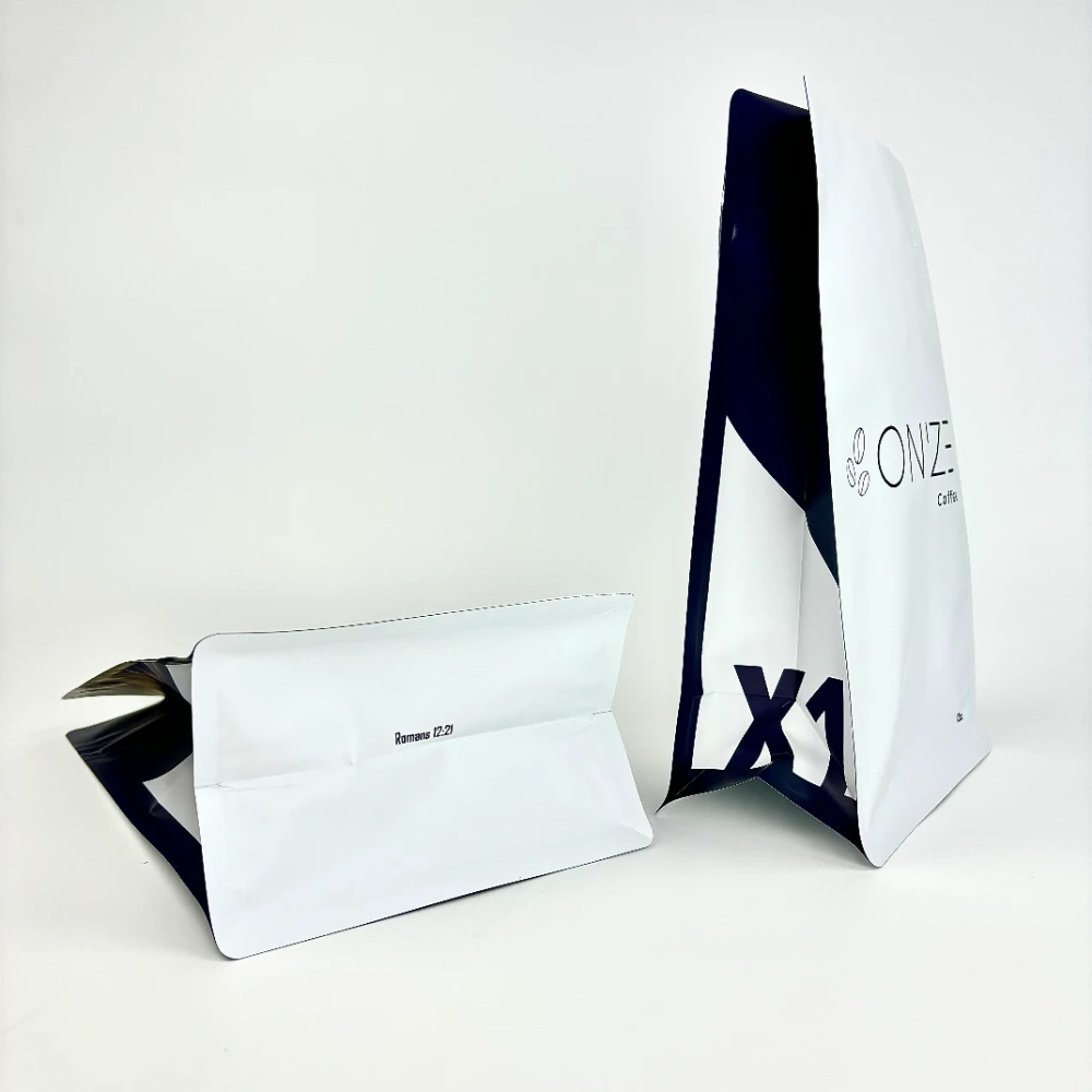JINYI custom white flat-bottom coffee bag side view — showing structured quad-seal base and minimal branding on high-barrier flexible packaging