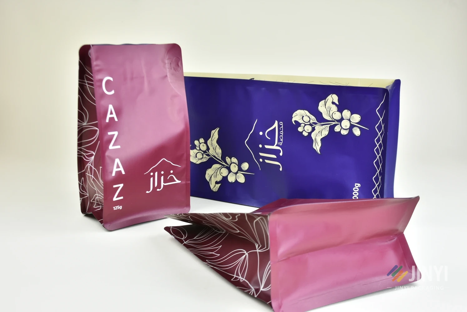 JINYI custom printed flat bottom coffee bags in three sizes — matte finish with brand artwork, factory-direct production