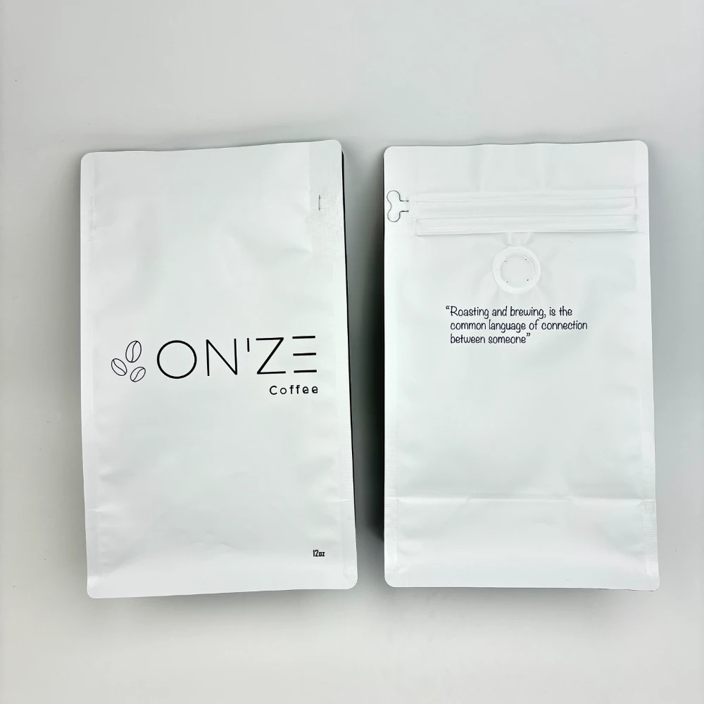JINYI custom flat-bottom coffee bags produced for ONZE Coffee — white minimal design specialty coffee packaging with clean typography and high-barrier film structure