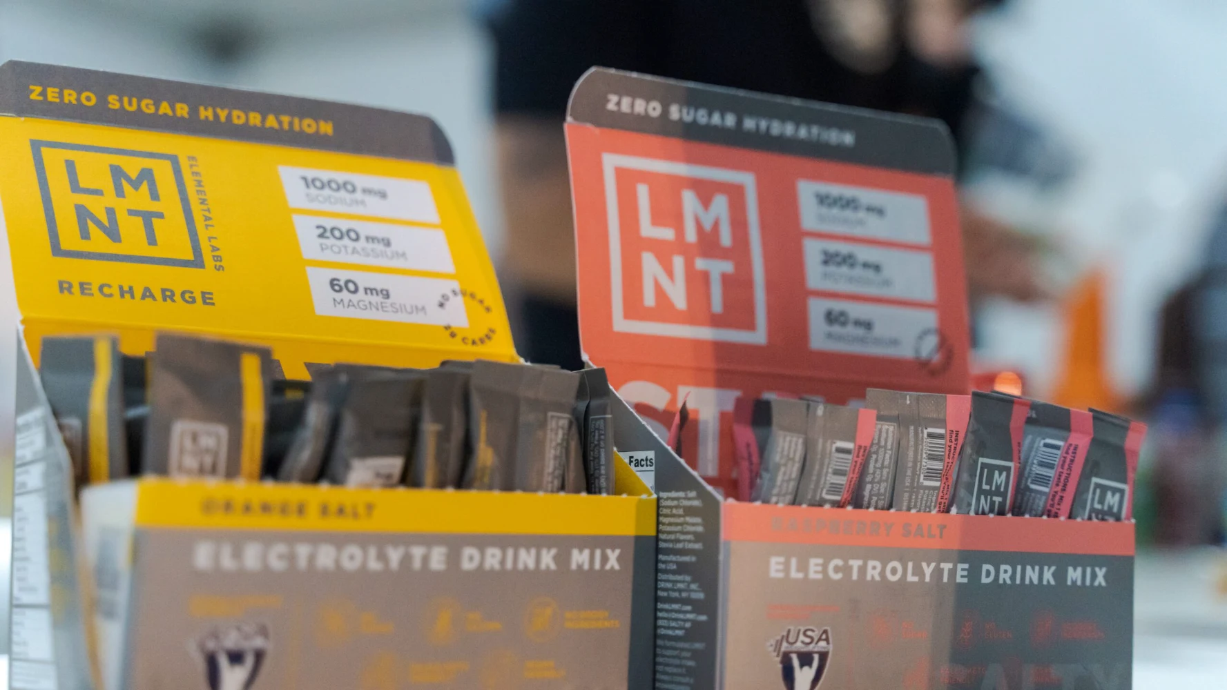 LMNT electrolyte stick pack product lineup — multiple flavors and carton packaging