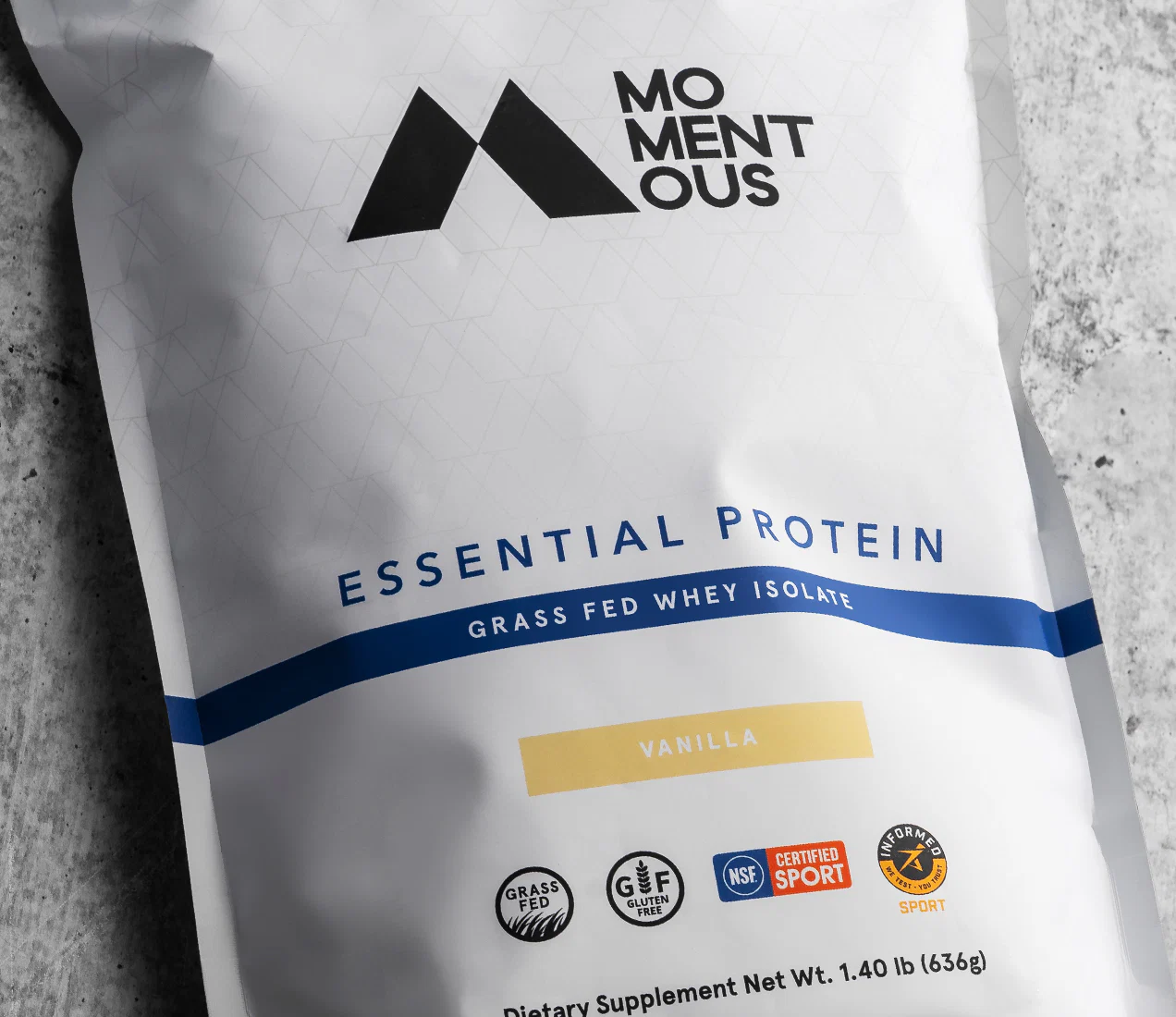 Momentous Essential Protein grass-fed whey isolate stand-up pouch — NSF certified supplement packaging front panel