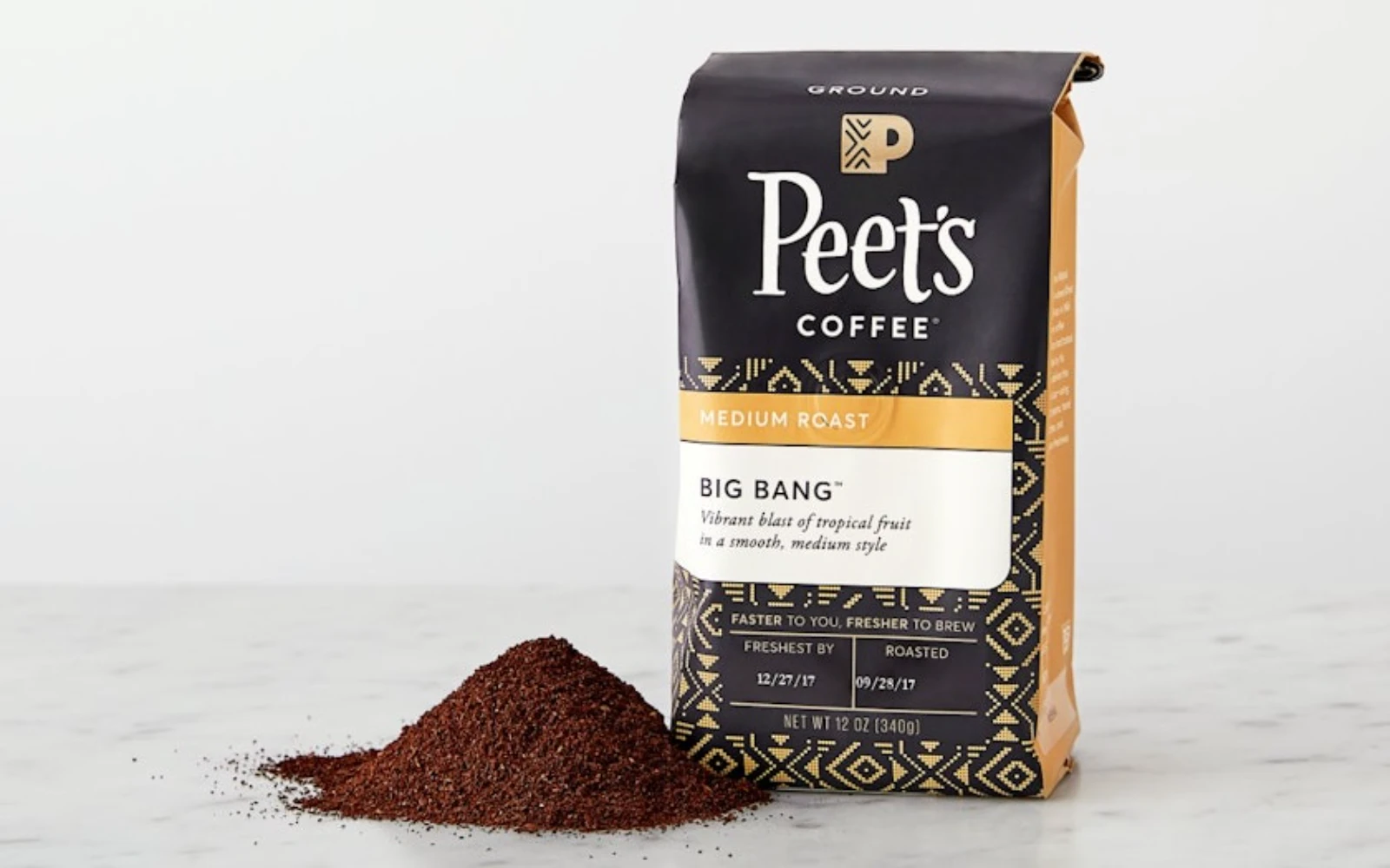 Peet's Coffee dark stand-up pouch retail packaging — PET AL PE high-barrier film structure with geometric design and roast date transparency