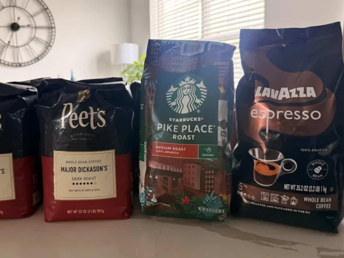 Peet's Coffee retail packaging alongside other specialty coffee brands — dark stand-up pouch with geometric design on grocery shelf