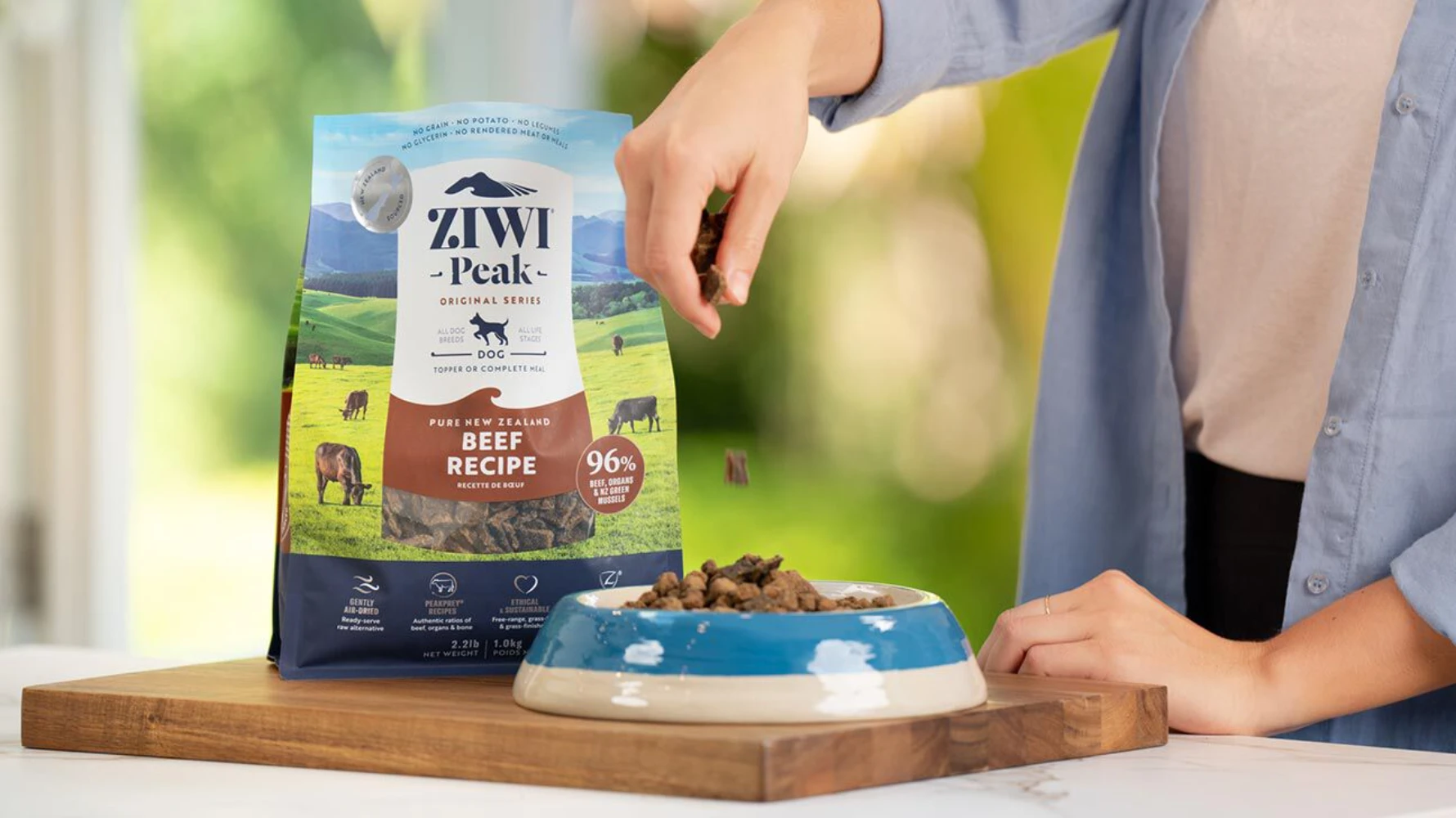 ZIWI Peak air-dried dog food being served — flat-bottom pouch packaging in feeding lifestyle context
