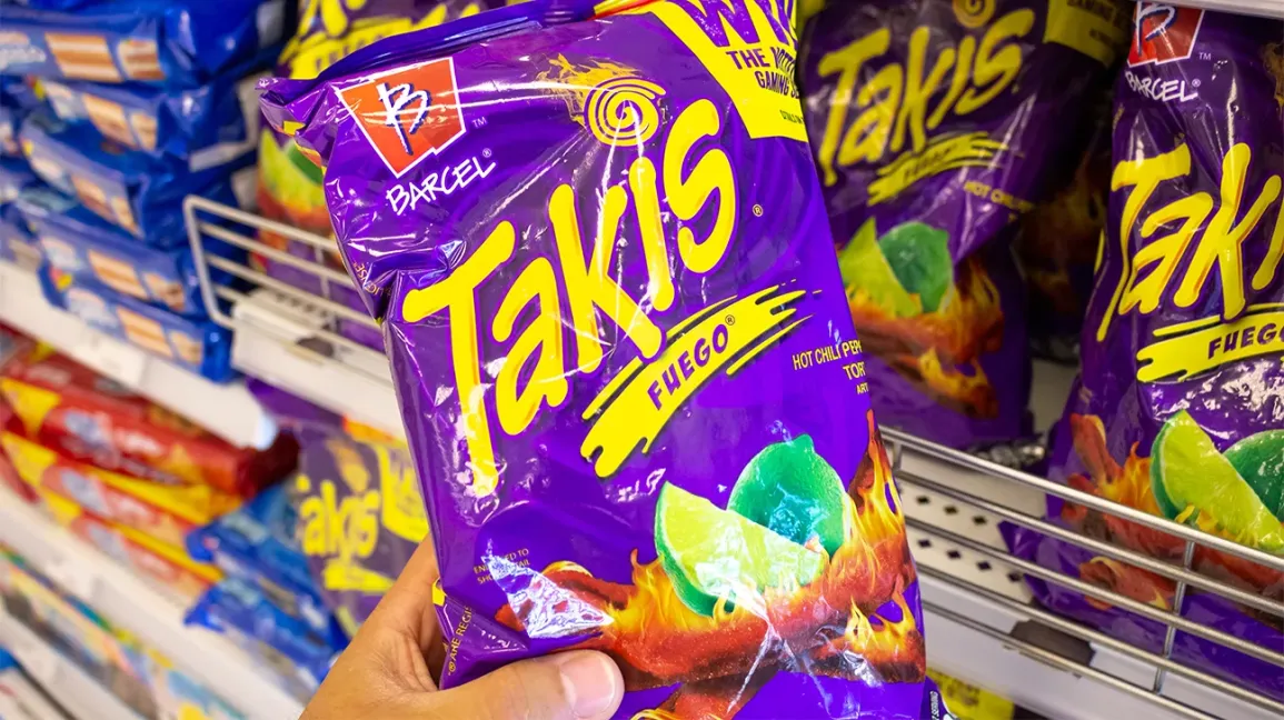 Takis purple chip bags displayed on a retail store shelf