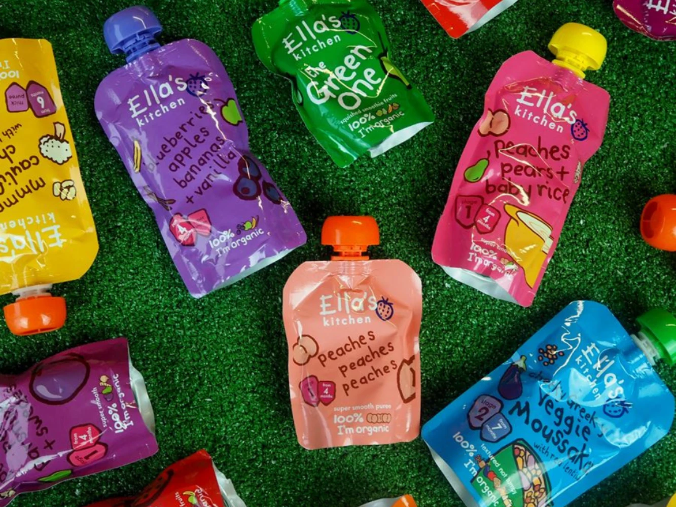 Colorful Ella’s Kitchen baby food spout pouches arranged on grass